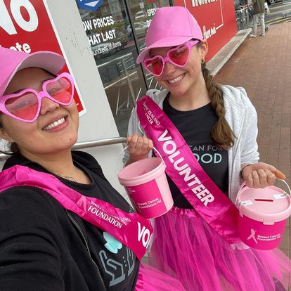Clean for Good team member volunteering in a pink sash